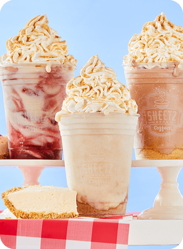 cheezecake shakes on a picnic table on top of a blue background
