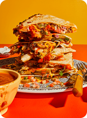 stack of quesadillas on a colorful background
