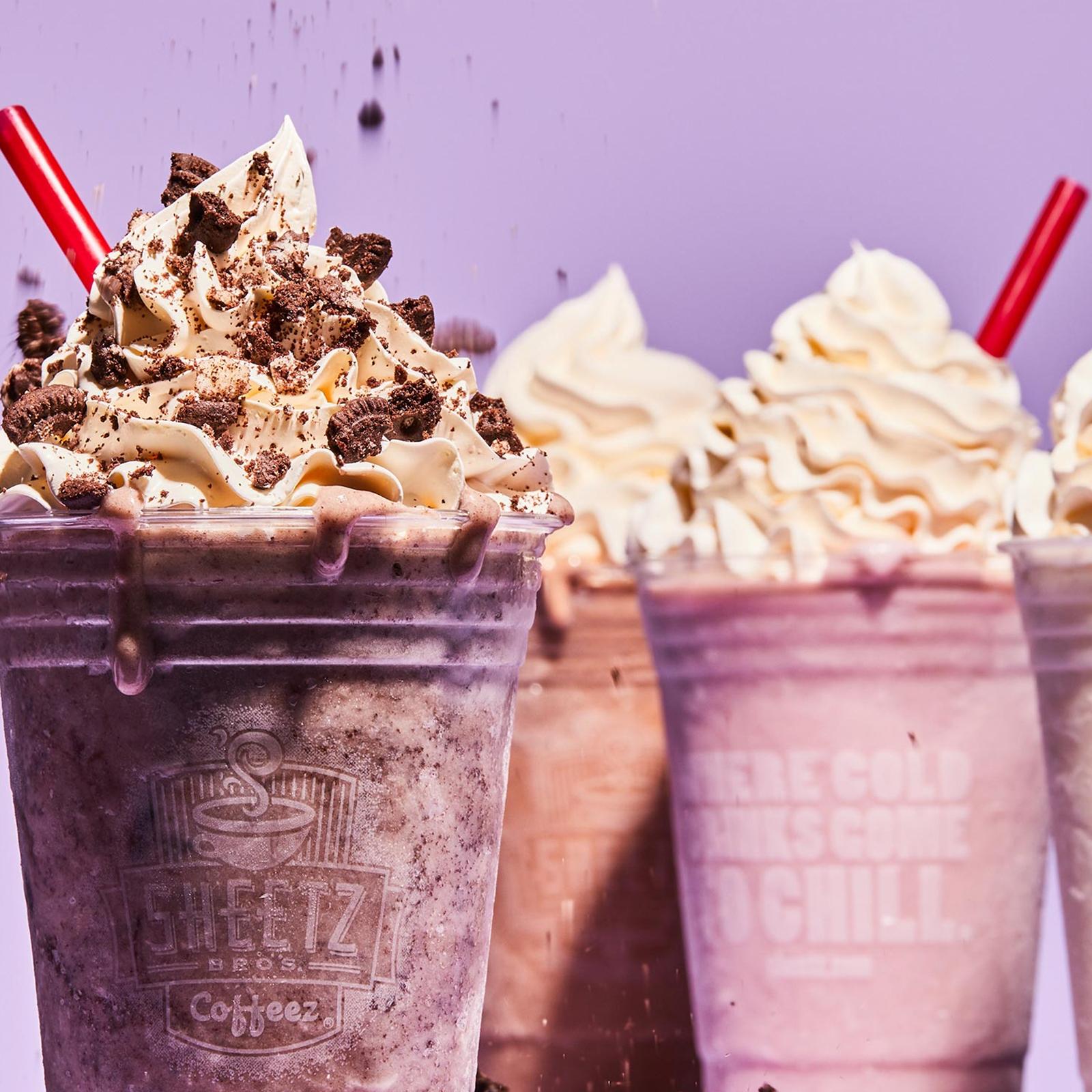 group of milkshakes on a purple background